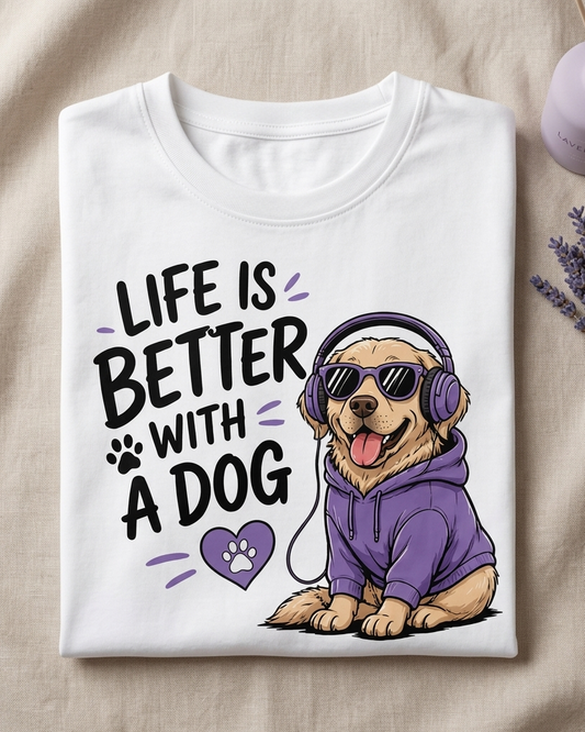 White t-shirt with a dog graphic and text 'Life is better with a dog' on a beige fabric background.